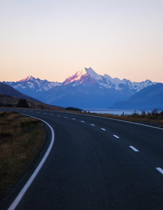 road with mt.cook in the background. check driving restrictions before traveling internationally.