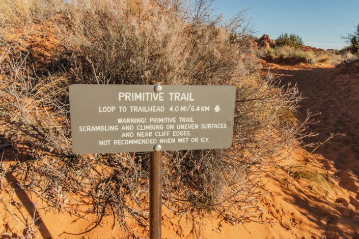 hikes in arches park primitive trail sign on the devil's garden hike in arches national park