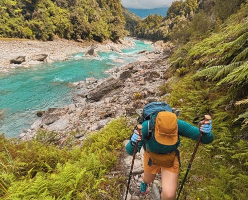 a hat, backpack, and sunglasses should be on your packing list for a day hike