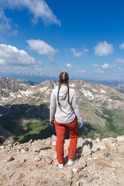 Emma standing on the summit of Mount Democrat, a popular Colorado 14er near Kite Lake