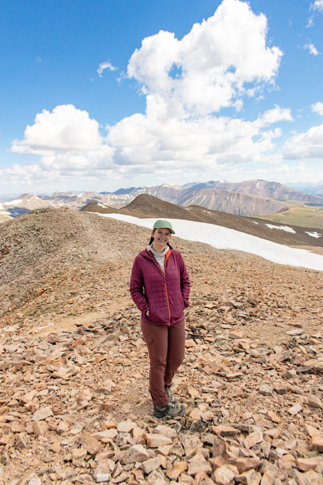 Emma hiking 14ers on the summit of Mount Sherman, one of the easiest and most beginner-friendly 14ers in Colorado