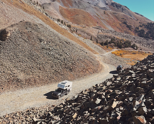 Truck camper parked at the summit of Ophir Pass Colorado showing 4WD vehicle requirements