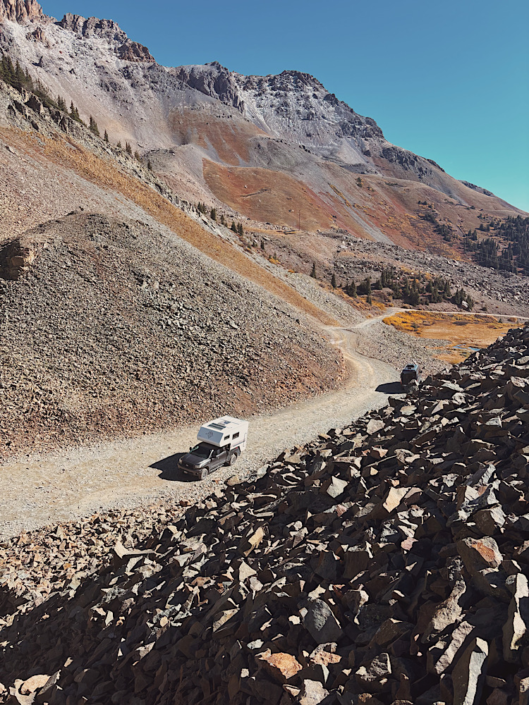 Truck camper parked at the summit of Ophir Pass Colorado showing 4WD vehicle requirements