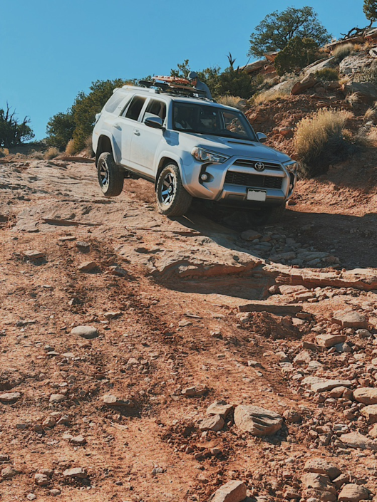 4Runner descending a steep rocky hill in the Maze in Canyonlands highlighting challenging off-road driving conditions