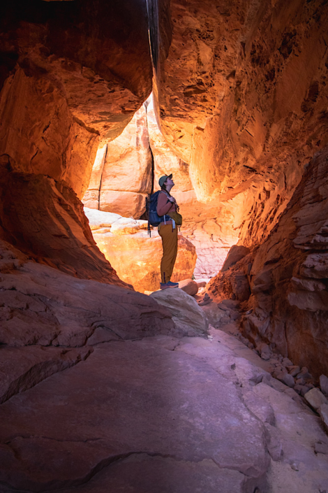 emma in the needles district of canyonlands in utah hiking in a tunnel formation
