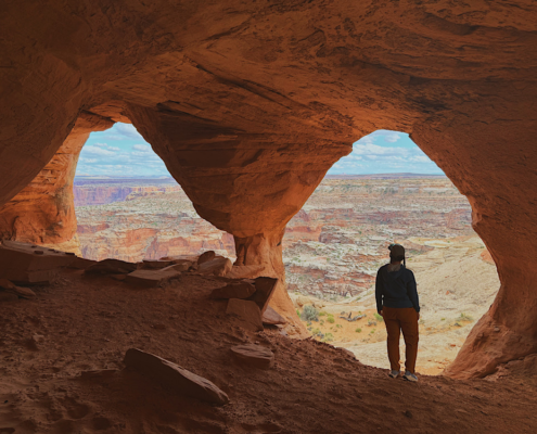 View through a column at Colonnade Arch creating two arch openings with canyon landscape beyond