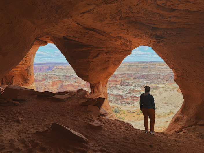 View through a column at Colonnade Arch creating two arch openings with canyon landscape beyond