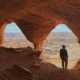 View through a column at Colonnade Arch creating two arch openings with canyon landscape beyond