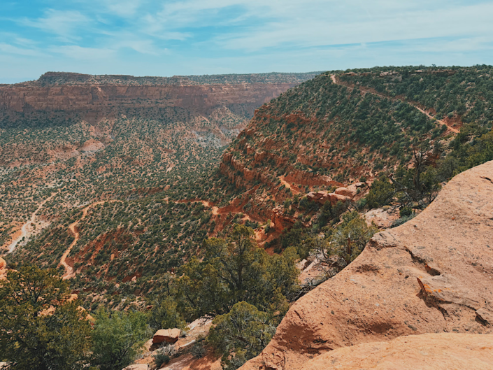 View from above of the Flint Trail switchbacks in the Maze in Canyonlands showing steep and rugged 4WD road