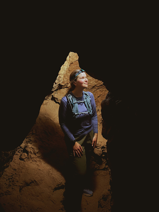 Headlamp lighting up a narrow passage inside Goblin’s Lair in Goblin Valley Utah