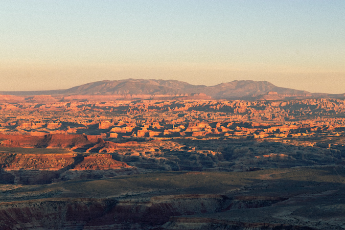 sunrise looking at needles district from panorama point campsite in the canyonlands maze