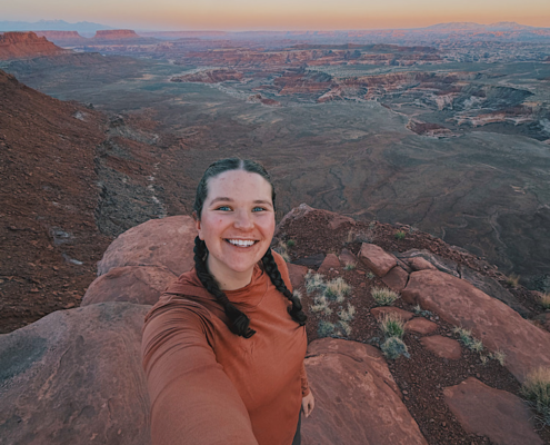 Taking a sunset selfie at Panorama Point in the Maze Utah with dramatic canyon views in the background