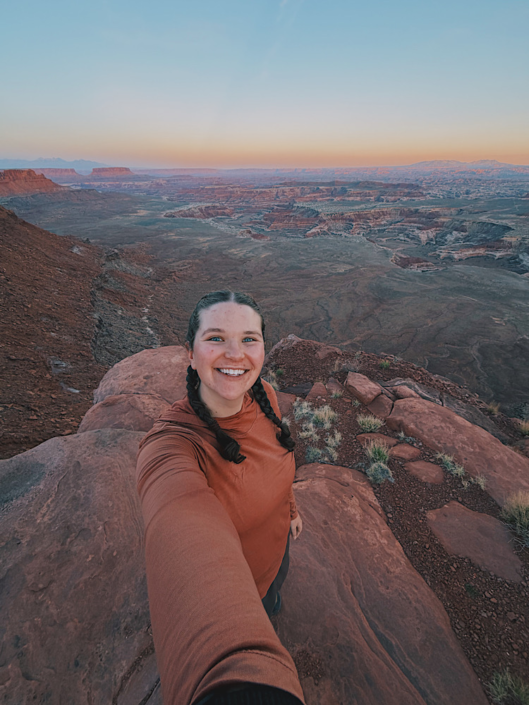 Taking a sunset selfie at Panorama Point in the Maze Utah with dramatic canyon views in the background