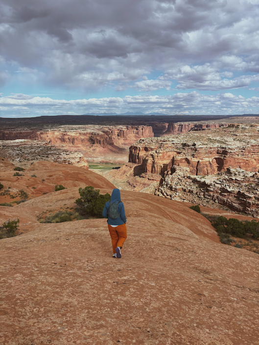 Walking across slickrock terrain on the route to Colonnade Arch in Utah