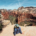 Emma sitting on cliff at the summit of the Angels Landing hike in Zion National Park overlooking Zion Canyon