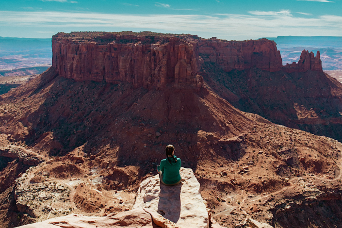 Hiker enjoying the canyon views from Grand View Point in Canyonlands National Park.