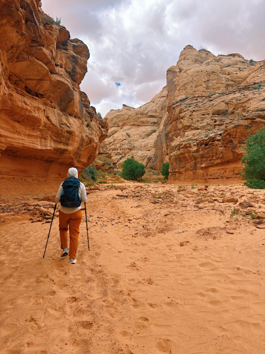 Hiker crossing the sandy wash in Horseshoe Canyon on the way to the Great Gallery.