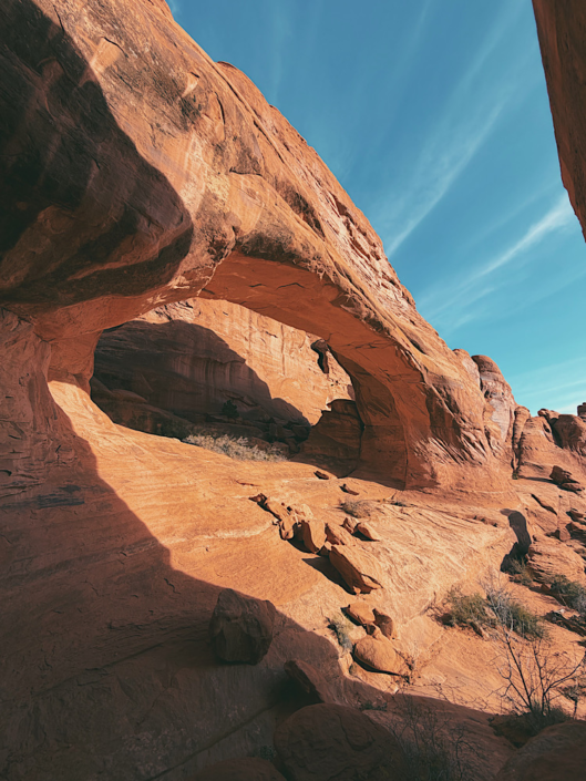Tower Arch in Arches National Park surrounded by red sandstone formations.