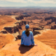 Hiker overlooking the White Rim from White Rim Overlook in Canyonlands National Park.