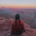 Hiker sitting on a cliff at Panorama Point in the Maze District of Canyonlands National Park