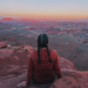 Hiker sitting on a cliff at Panorama Point in the Maze District of Canyonlands National Park