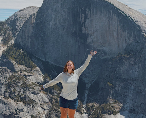Hiker on the North Dome trail with Half Dome in the background, Yosemite National Park