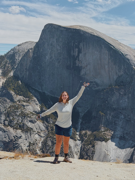 Hiker on the North Dome trail with Half Dome in the background, Yosemite National Park