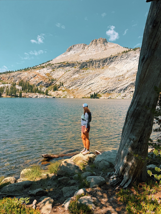 may-lake-yosemite-hike-alpine-lake Hiker standing in front of May Lake in Yosemite National Park