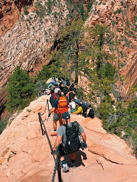 Crowds waiting along the Angels Landing trail in Zion National Park on a busy hiking day.