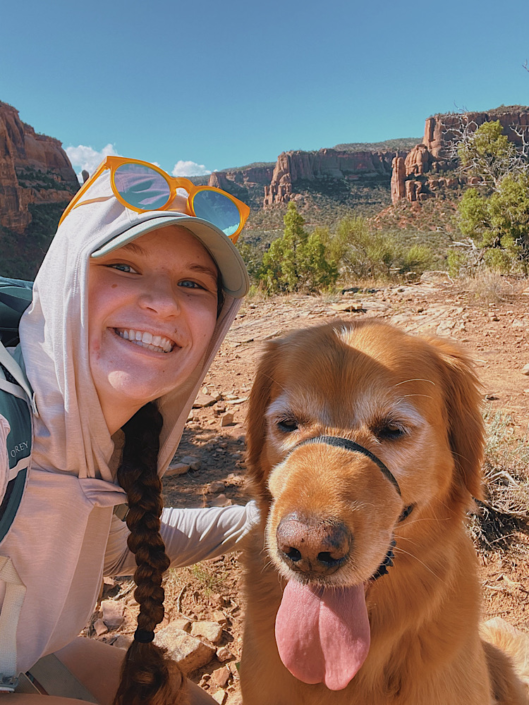 Hiker with a golden retriever on a desert hiking trail