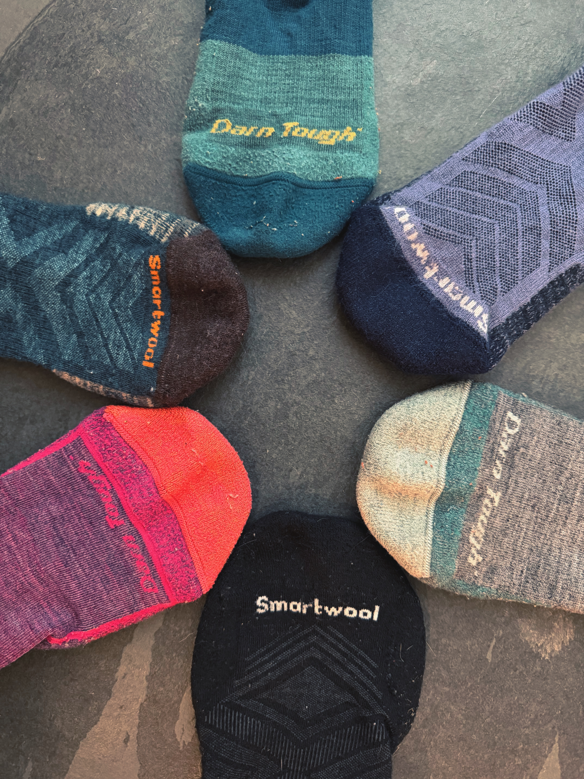 Collection of Darn Tough and Smartwool merino wool hiking socks in different weights and styles