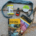 Hiking guidebooks, Garmin inReach, sunscreen, energy chews, and cooling neck tie arranged on a rock