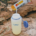 Pouring Skratch Labs electrolyte powder into a water bottle while hiking