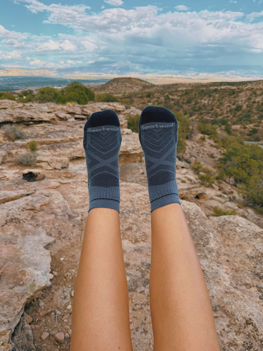 Smartwool merino wool hiking socks worn on a rocky overlook