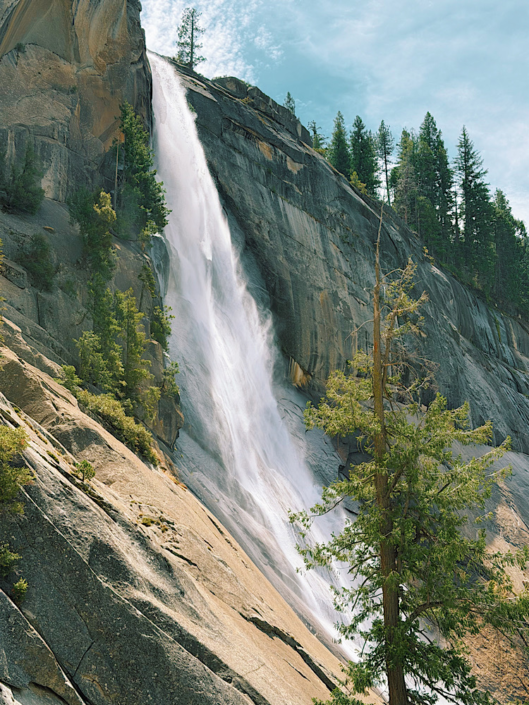 Side view of Nevada Fall cascading down granite beside the Mist Trail in Yosemite