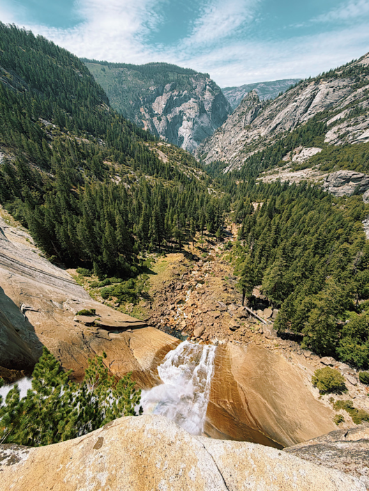 Looking over the edge of Nevada Fall toward the forested valley below in Yosemite