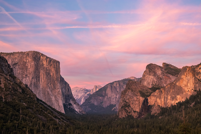 Pink sunset over Yosemite Valley from Tunnel View, with El Capitan, Half Dome, and Bridalveil Fall in the distance.