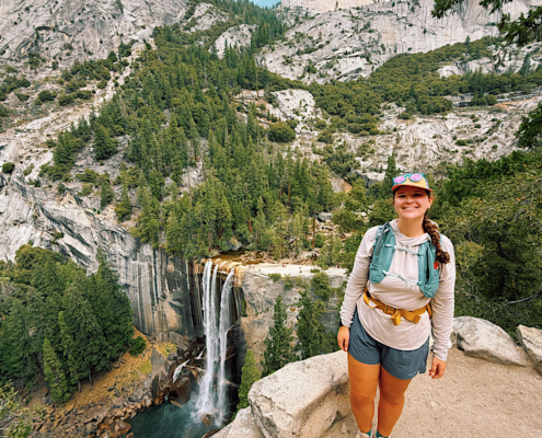 Hiker overlooking Vernal Fall on the Vernal and Nevada Falls hike in Yosemite