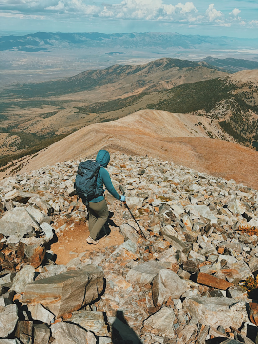Hiker descending the rocky Wheeler Peak Trail with views across Great Basin National Park